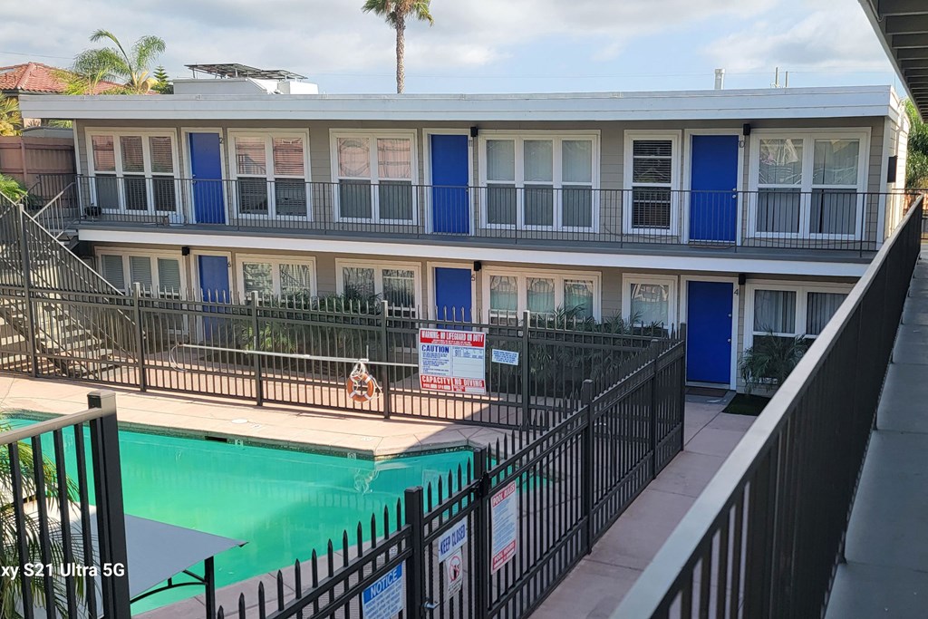 View of swimming pool from second floor veranda at 5747 Lauretta Street Apartments in San Diego, California.