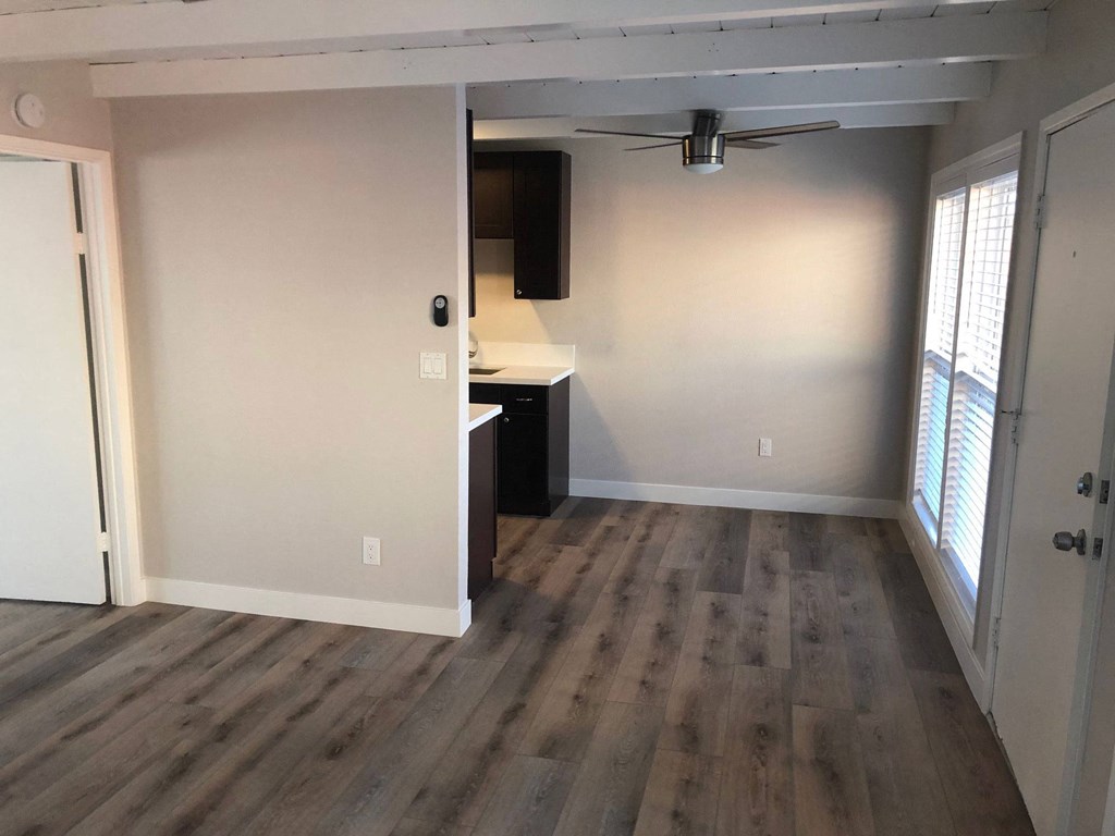 Living room view of dining room and kitchen area at 5747 Lauretta Apartments in San Diego California.