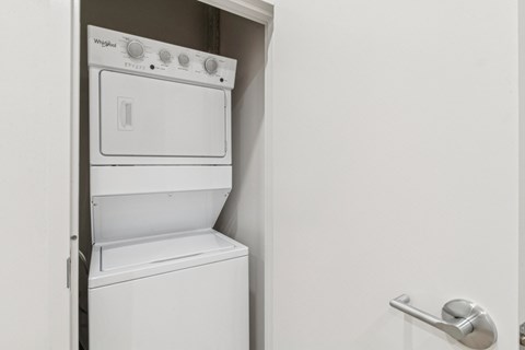 A white washing machine is in a small space.