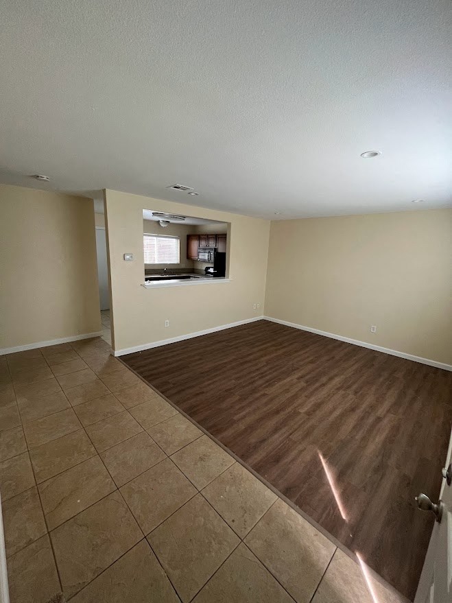 Front entry view of living room and kitchen passthrough at 980 E Mission Avenue Apartments in Escondido.