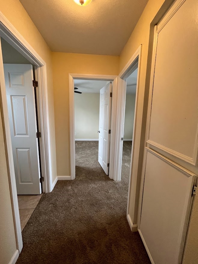 Carpeted hallway to upstairs bedrooms at 980 E Mission Avenue Apartments in Escondido, CA.