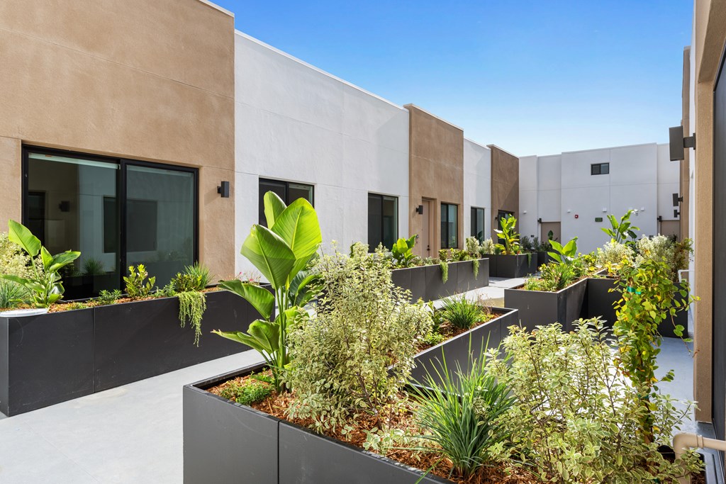 A modern building with a garden in front.