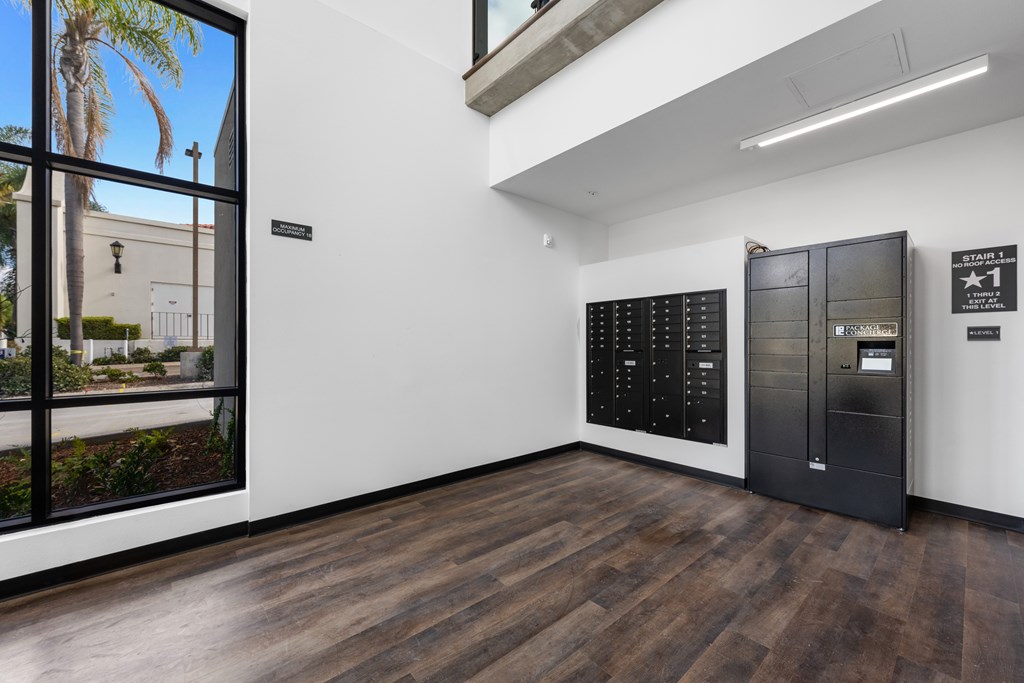 A room with a black fridge and freezer, a black cabinet, and a black shelf.