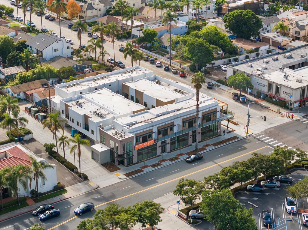 A street view of a residential area with a building in the center.