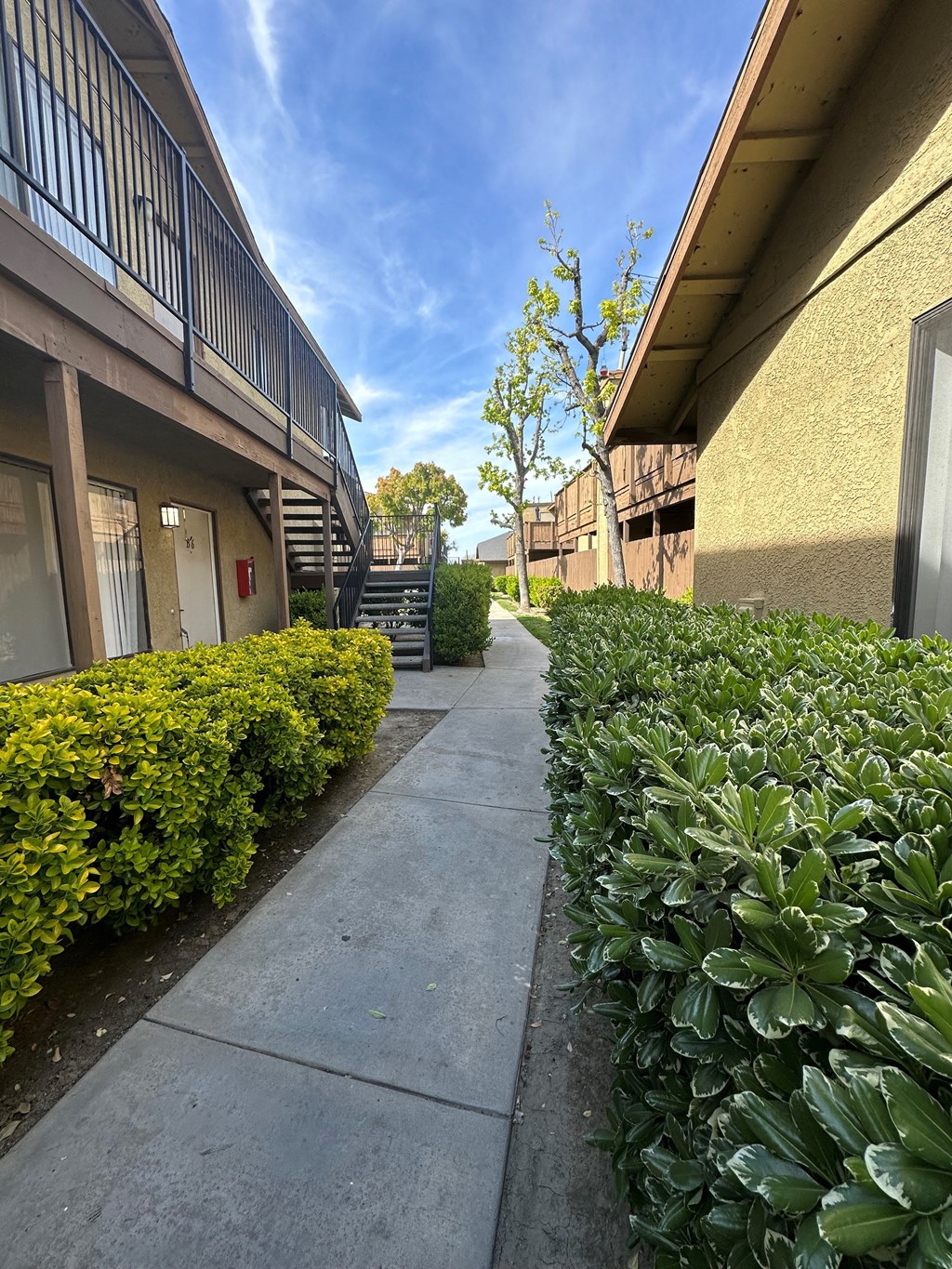 Walkway between buildings at Riverdale Apartment Homes in Hemet, California.