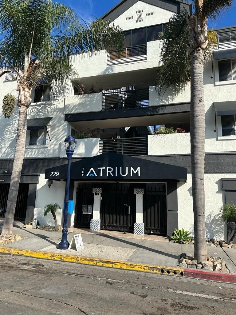 Sidewalk view of front enterance at the Atrium Apartments in downtown San Diego, CA.