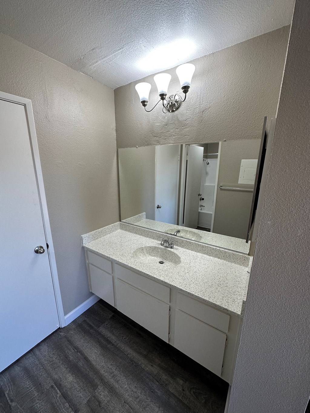 Bathroom vanity with private bathtub/shower/toilet at Park Yale Apartments in Hemet, California.