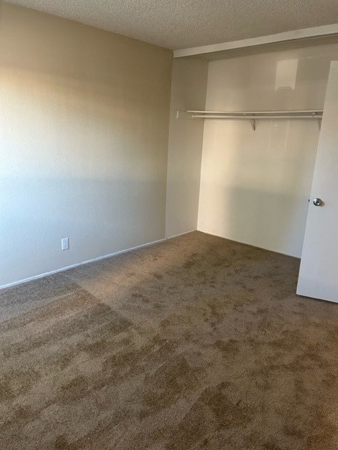 Spacious bedroom with large closet at Mission Bell Apartmentss.