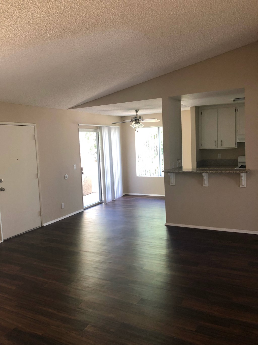 View of dining room , private poarch and kitchen from living room at Grande Vista Apartments.