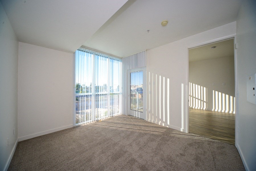 Master bedroom with carpet and fantastic light and views at 12th Street Lofts in National City, California.