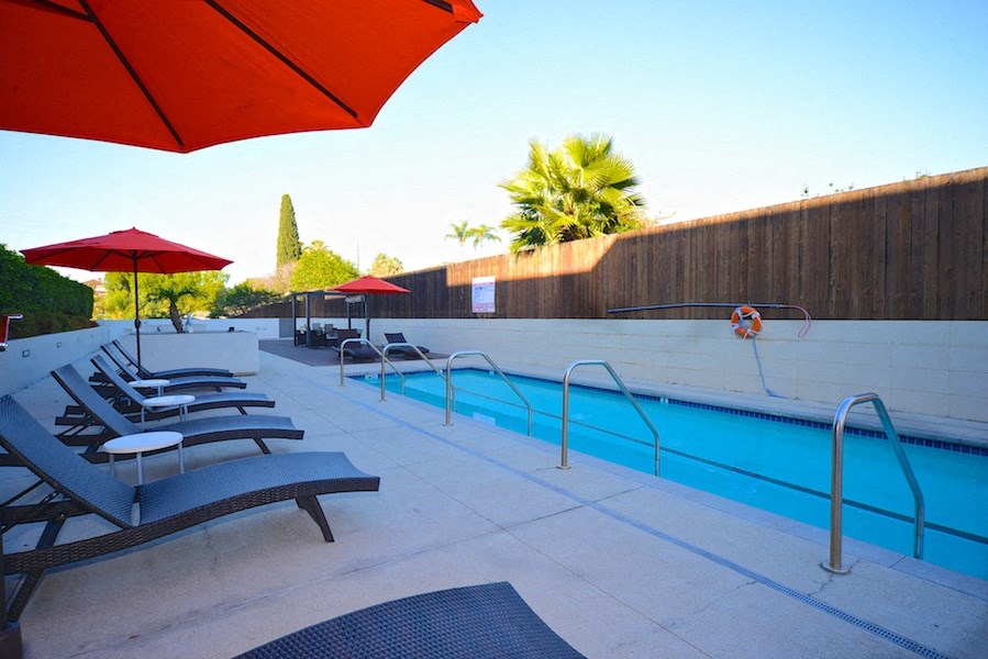 Plenty of chaise lounge chairs and umbrellas on the sun deck at 12th Street Lofts in National City, California.