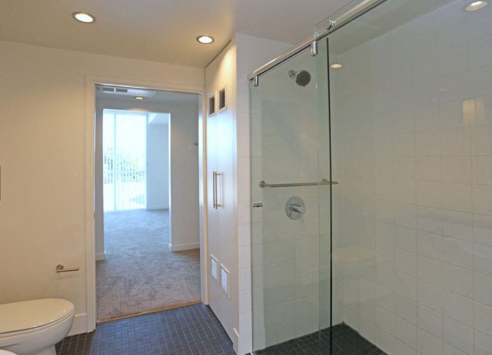 Bathroom with closed laundry doors and clostes for front bedroom at 12th Street Lofts in National City, California.