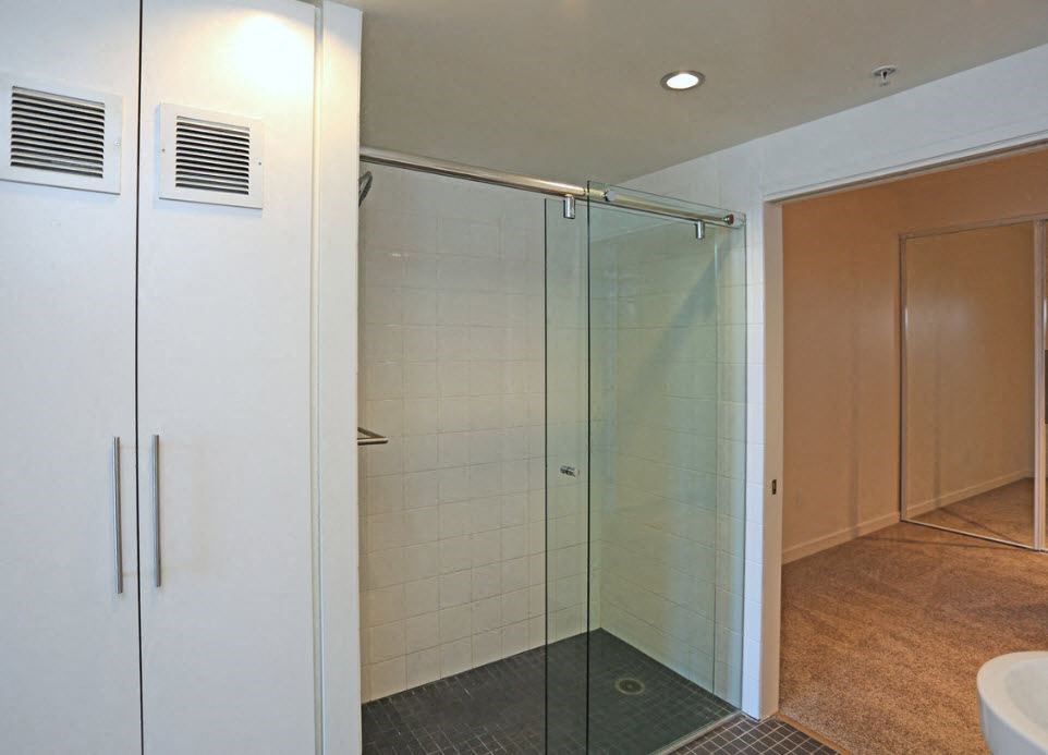 Bathroom and carpeted bedroom at 12th Street Lofts in National City, California.