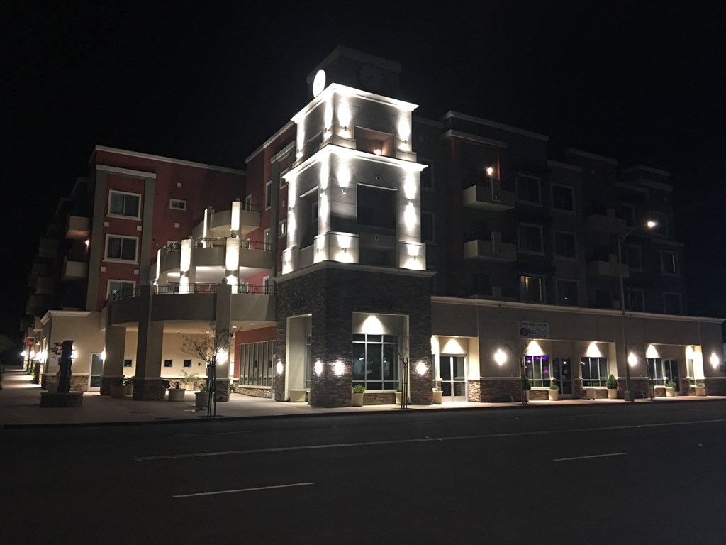 Night time stree view of City Plaza Apartments in Escondido, California.