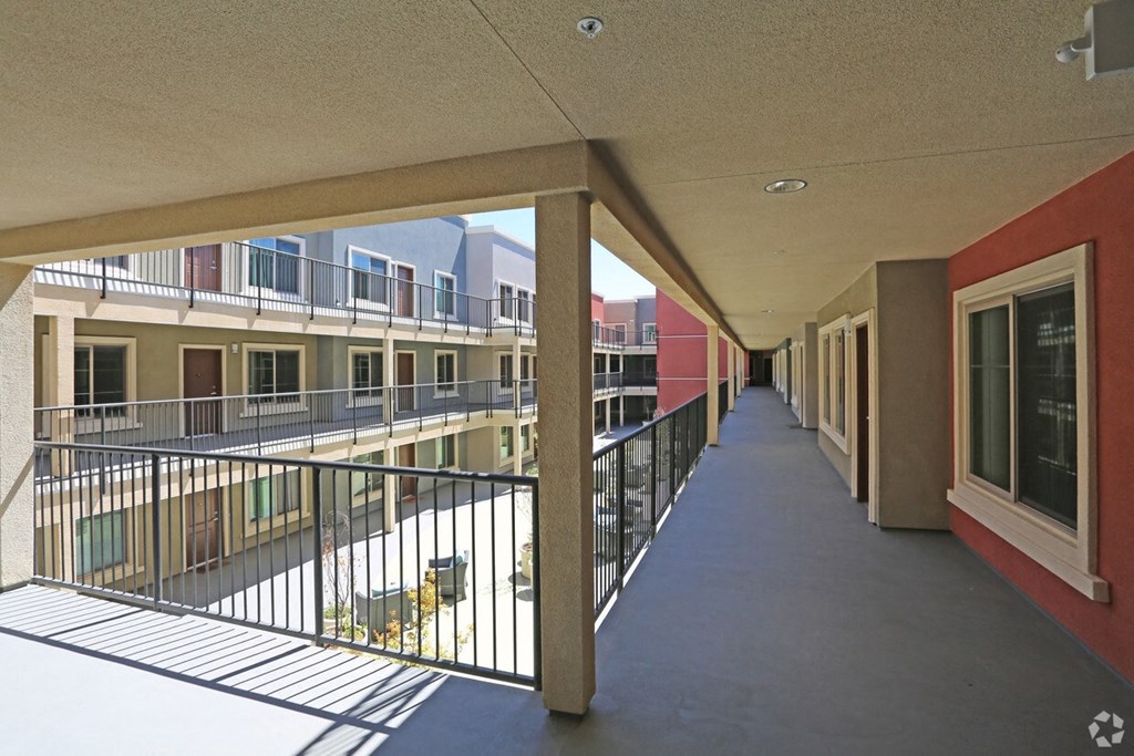 Inner access to apartments with view of courtyard at City Plaza Apartments in Escondido, California.