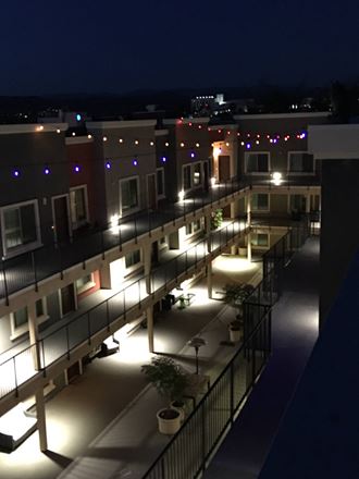 Night time view of inner courtyard at City Plaza Apartments in Escondido, California.