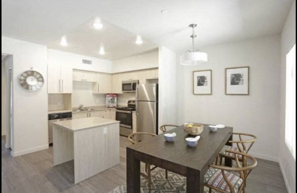 Dining room and kitchen in apartment at City Plaza Apartments in Escondido, California.