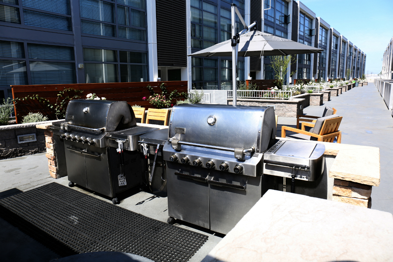 Community BBQ area with two grills table and chairs