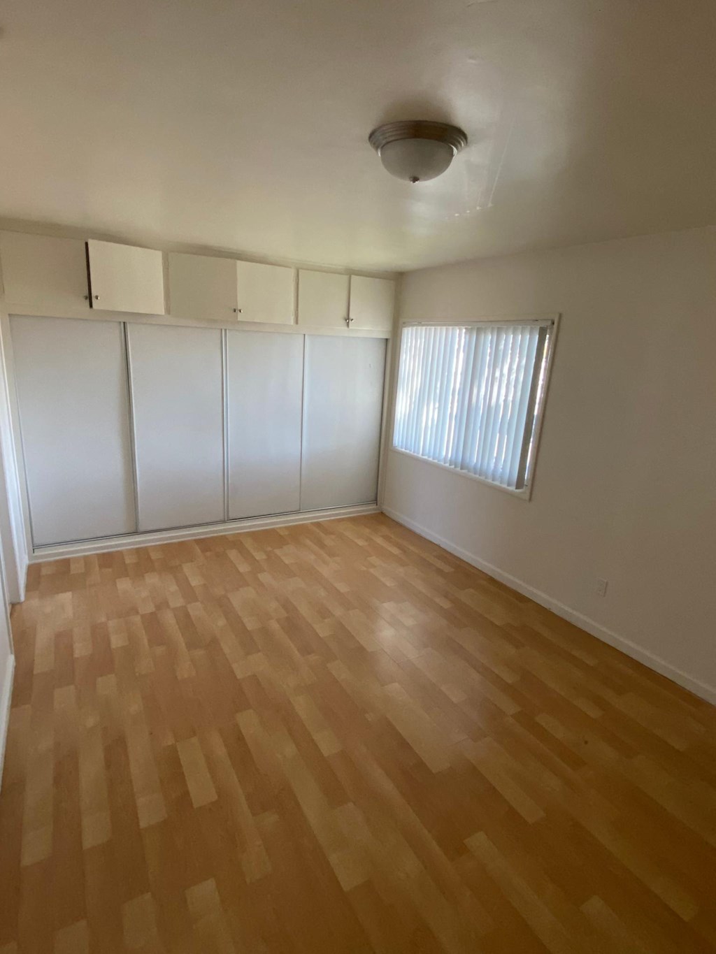 Bedroom with spacious closets and cupboards at Edison Apartments in Burbank, California.
