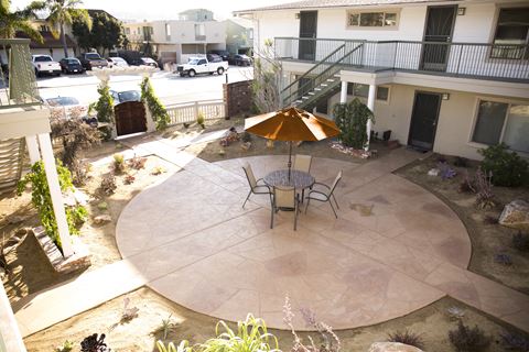 Patio sitting area in courtyard at Harbor Villa Apartments in  San Diego, California.