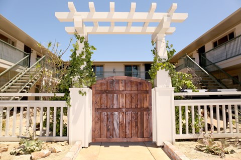 Wooden gate enterance to Harbor Villa Apartments in San Diego, California.
