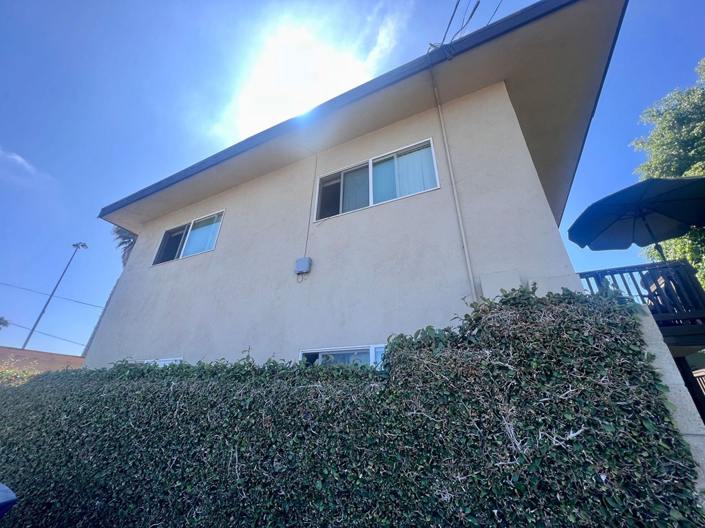 Back view of Higgins Street Apartments with deck in Oceanside, California.