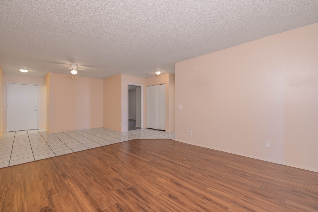 Empty room with wooden floors and white walls.