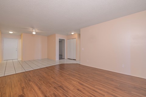 Empty room with wooden floors and white walls.