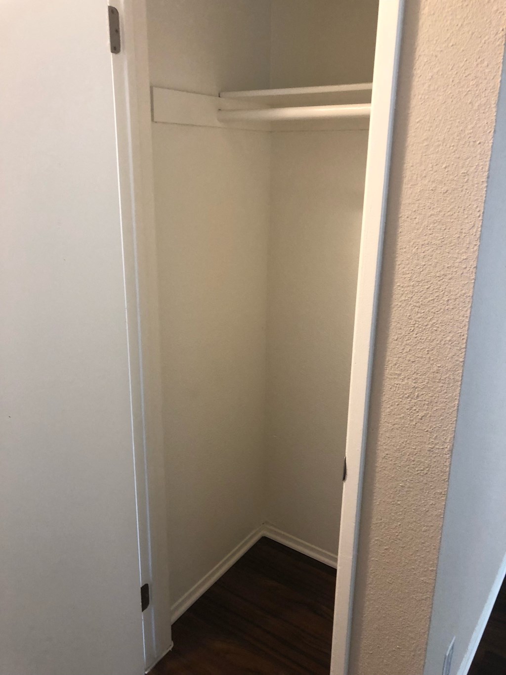 Roomy coat closet in hallway across from linen closet at Grande Vista Apartments.