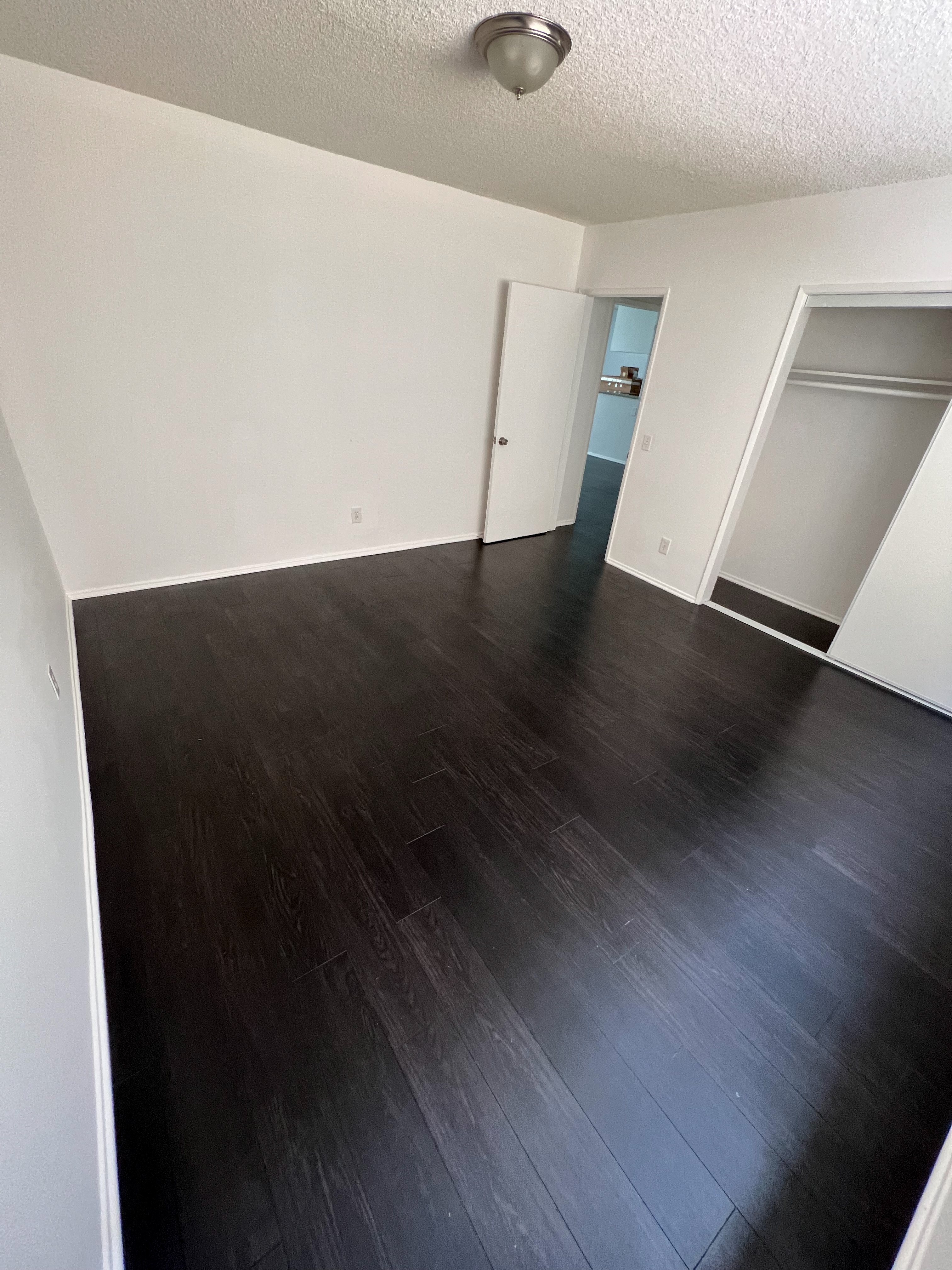 Bedroom with hardwood flooring and large closet at The Carlton in Hollywood, California.