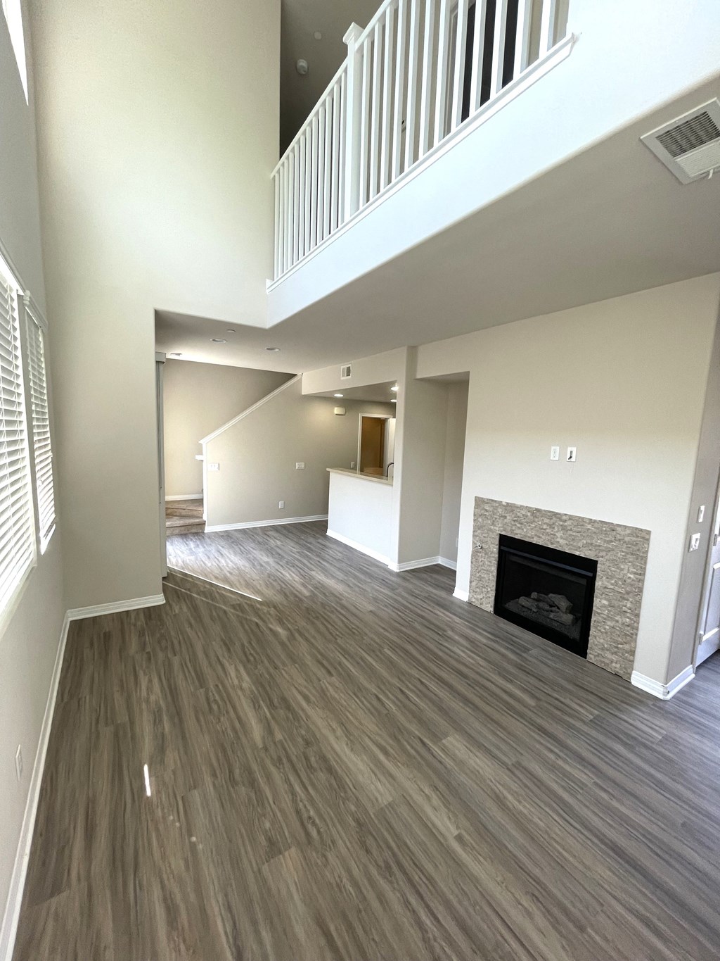 Neptune living room and dining room (Neptune floorplans located in the middle of the property feature fireplaces) at Costa Pointe Luxury Townhomes in Carlsbad, California.