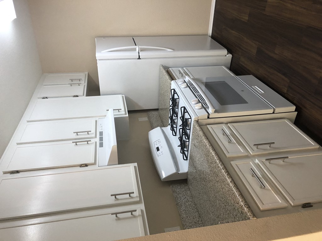 Beautiful white kitchen cabinets, white gas range and refrigerator at Grande Vista Apartments.