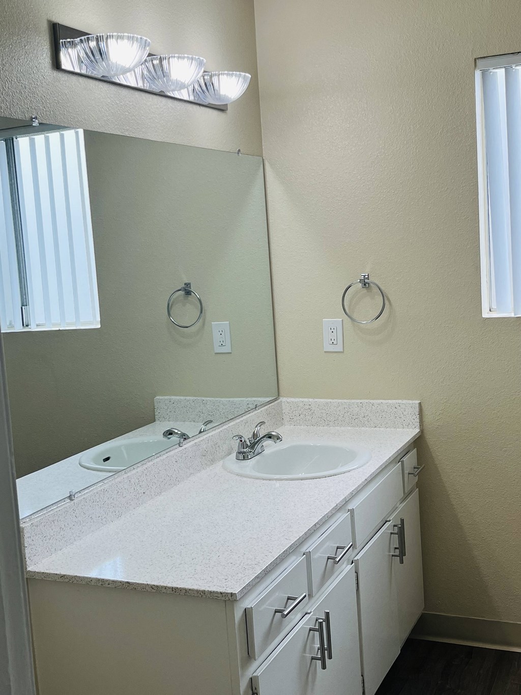 Bathroom with large vanity and window at Plaza Verde Apartments in Escondido, California.