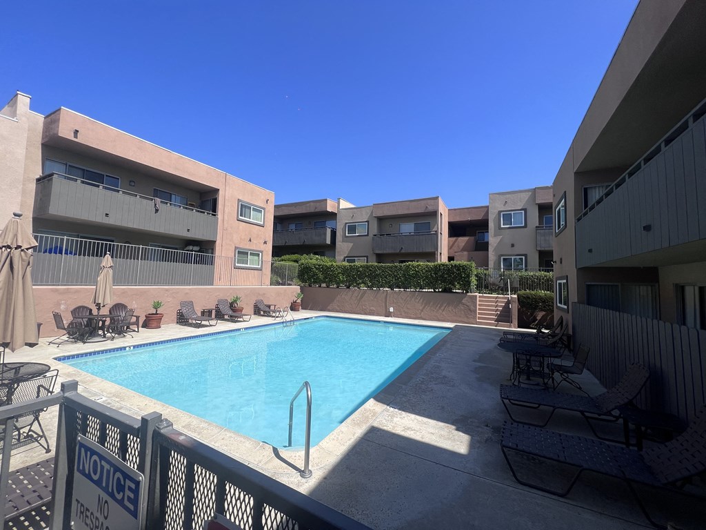 Swimming pool and sun deck at Villa Pacific Apartments in Oceanside, California.