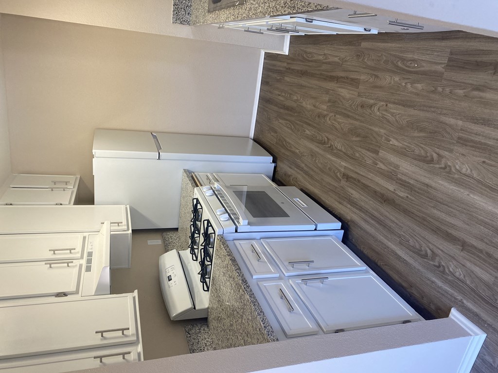 Newly modernized kitchens with gas stove, refrigerator, dishwasher, disposal and deep stainless steel sink at Grande Vista Apartments.