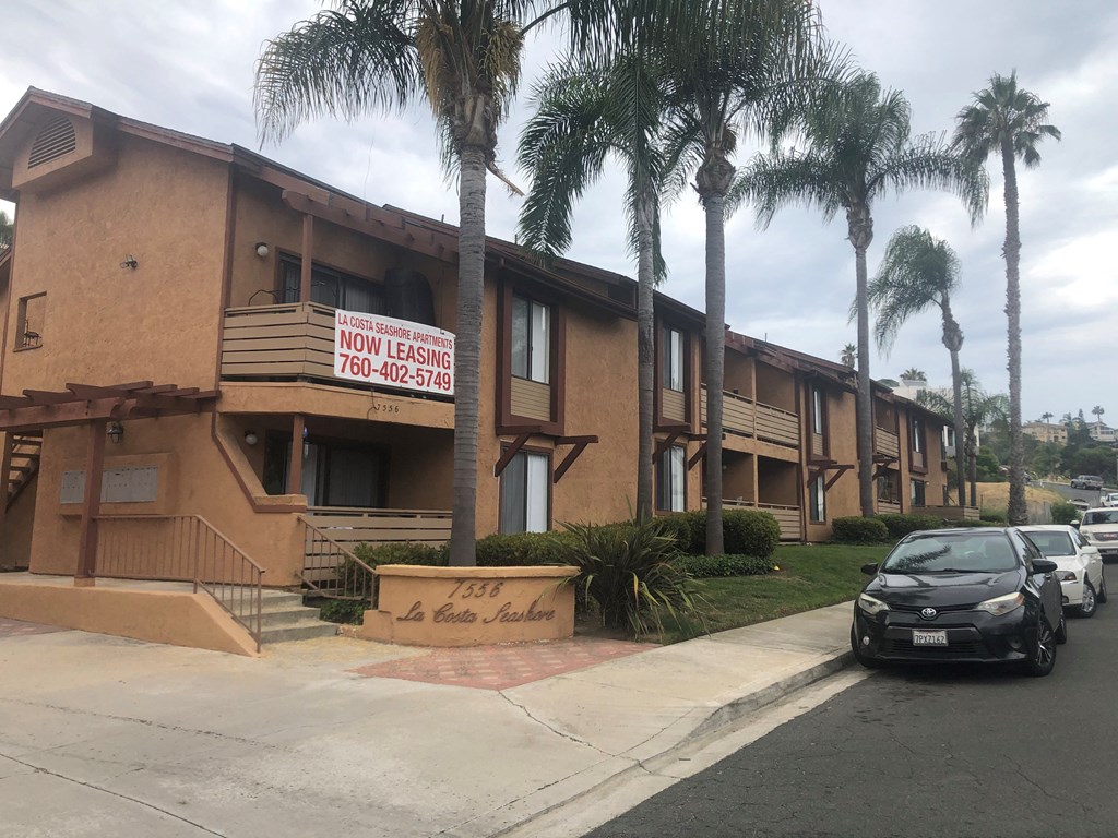 Street view of enterance of La Costa Seashore Apartments in Carlsbad, CA.