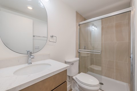 A bathroom with a sink, toilet, and shower.