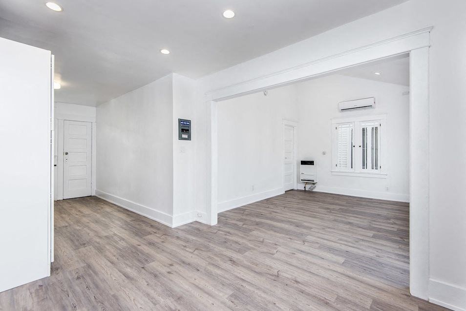Dining room looking into front room and kitchen at 4141 Normal Avenue apartment homes in Los Angeles, California.