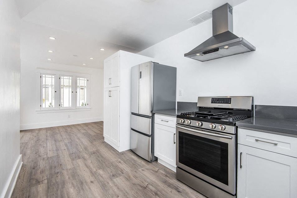Kitchen looking into dining room with fantastic windows and lighting at 4141 Normal Avenue Apartments in Los Angeles, California.