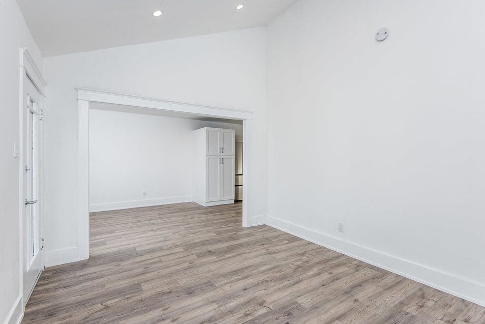 Front room looking into dining area and kitchen at 4141 Normal Avenue apartment homes in Los Angeles, California.
