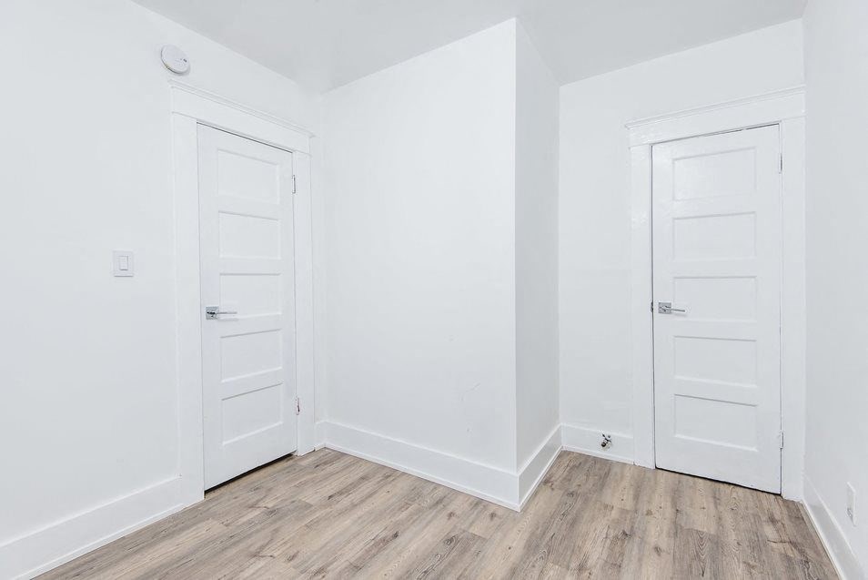Bedroom with door to bathroom at 4141 Normal Avenue apartment homes in Los Angeles, California.