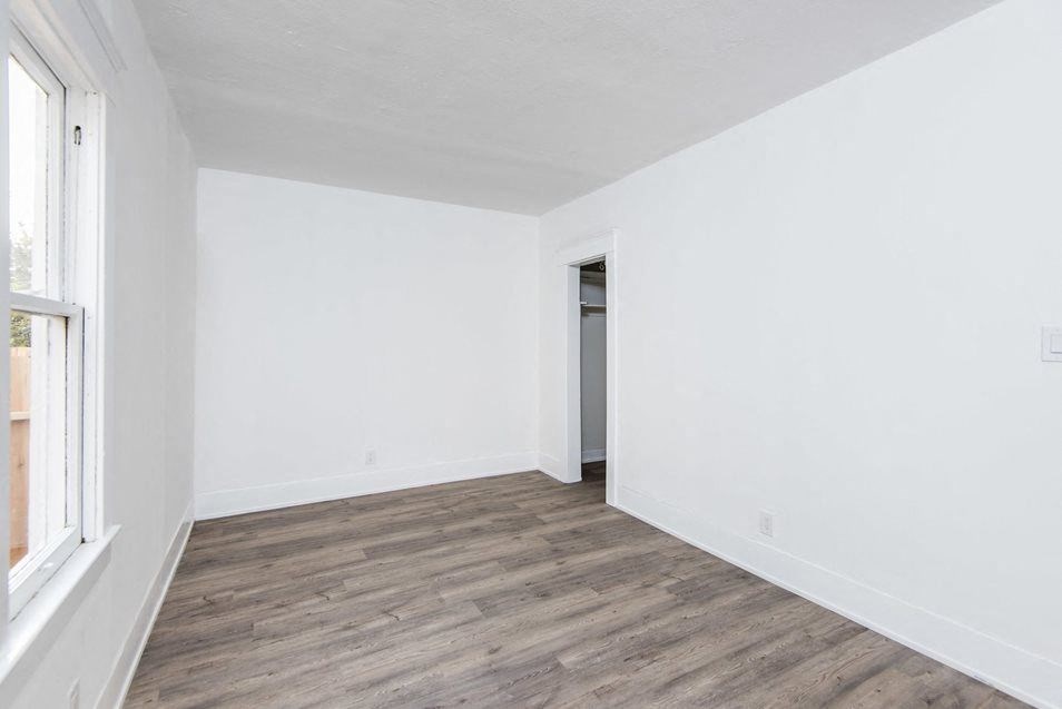 Bedroom with walk-in closet and wood plank style flooring at 4141 Normal Avenue in Los Angeles, California.