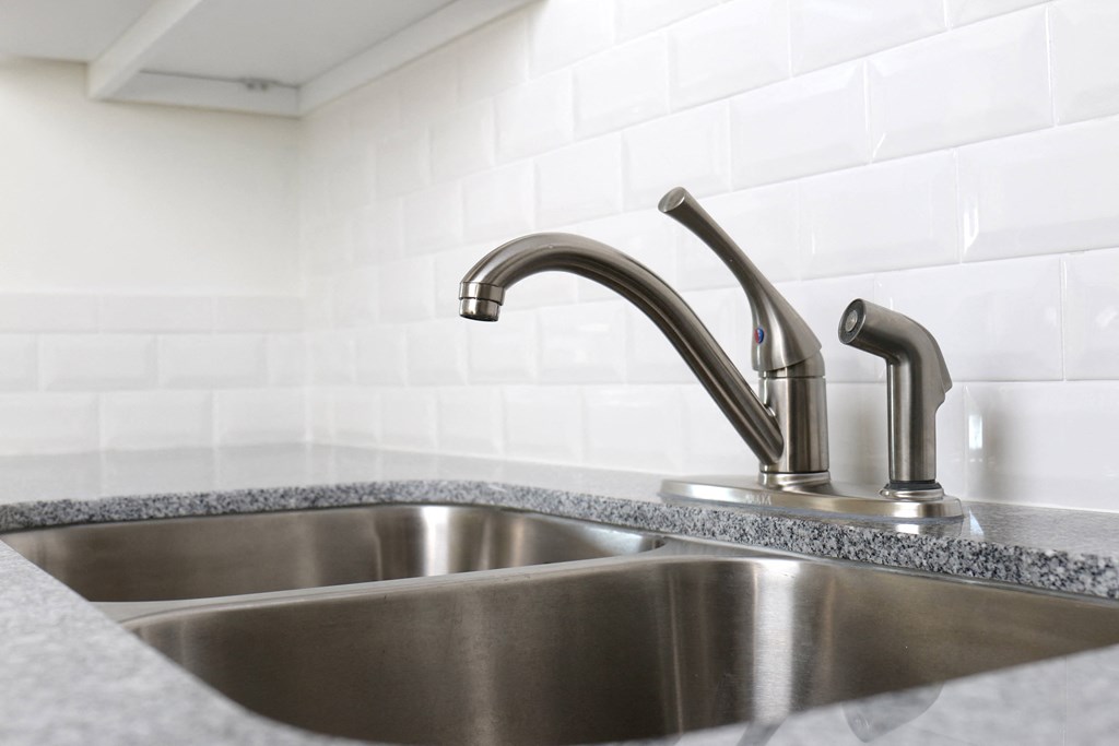 Upgraded kitchen fixtures and countertops at Harbor Villa Apartments in San Diego, California.