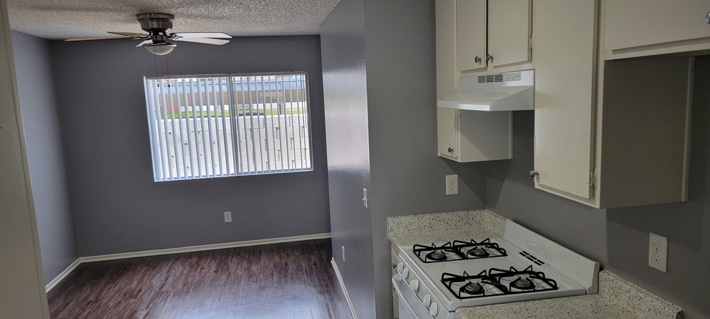 Kitchen view of dining room at Grand Oaks Apartments in Lake Elsinore, California.