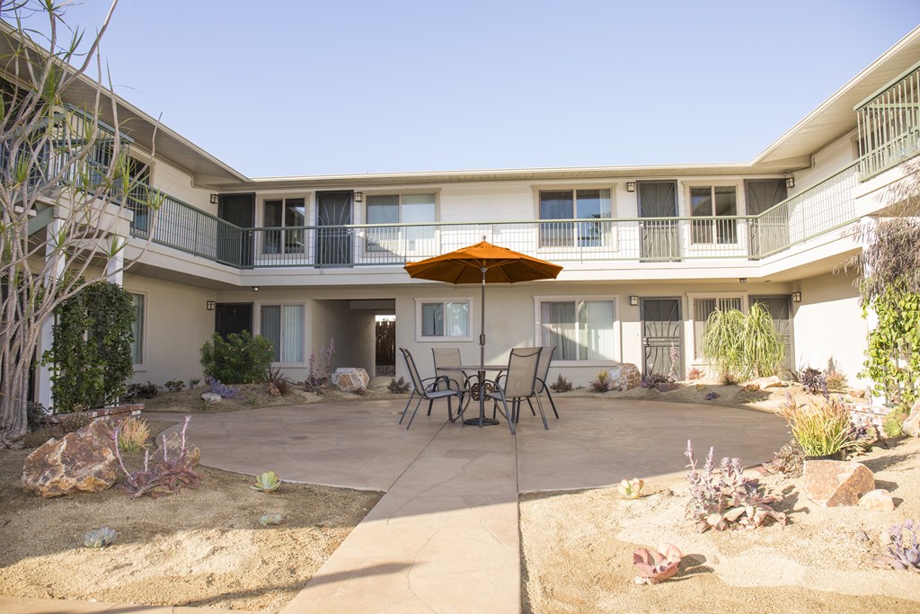 Courtyard view of second floor units at Harbor Villa Apartments in San Diego, California.