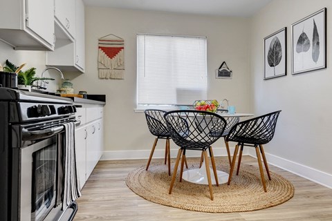 a kitchen with a table and chairs next to a stove