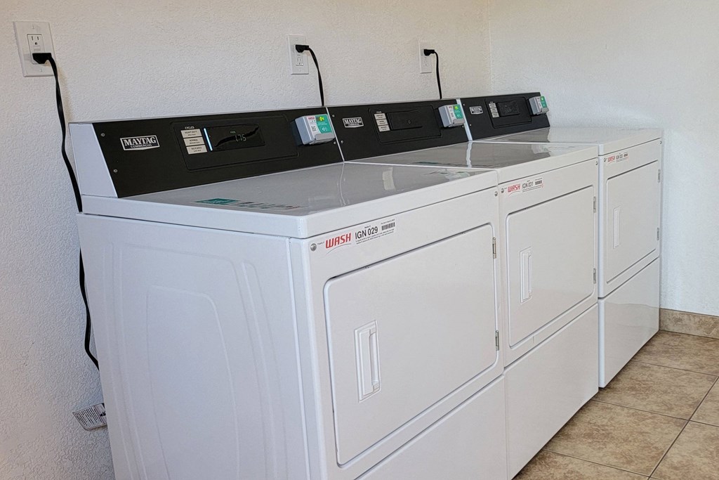 Laundry room dryers at The Willows at Washington apartments in El Cajon, California.