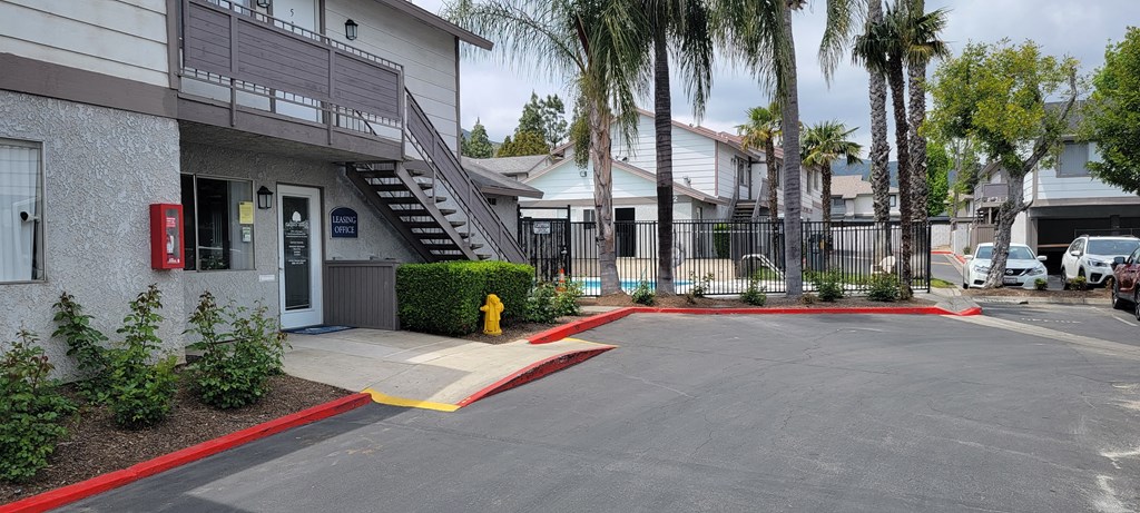 Leasing office and gated pool at Grand Oaks Apartments in Lake Elsinore, California.