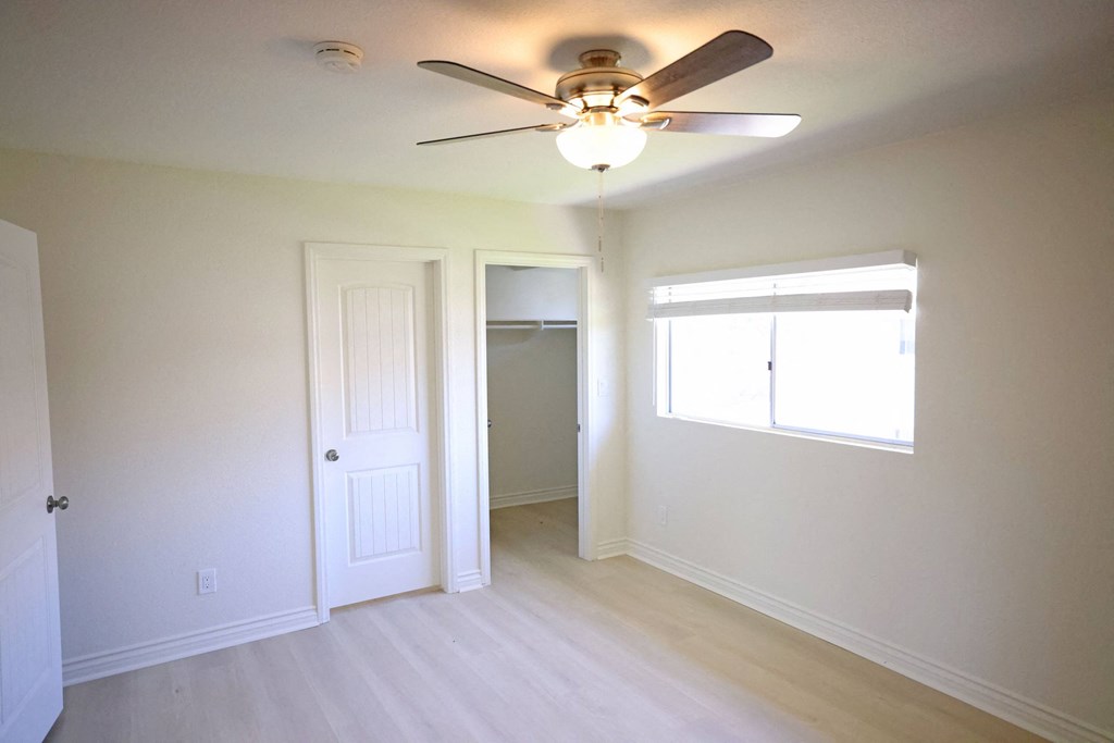 One of two large bedrooms with walk-in closet and private full bathroom at Lone Pine Townhomes.