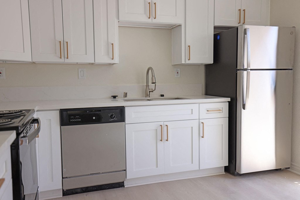 Kitchen with lots of white cabinets and natural light at Lone Pine Townhomes in El Cajon, California.